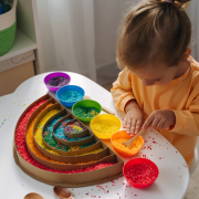 A,Little,Girl,Playing,Colored,Rice,And,Make,Rainbow.,Child